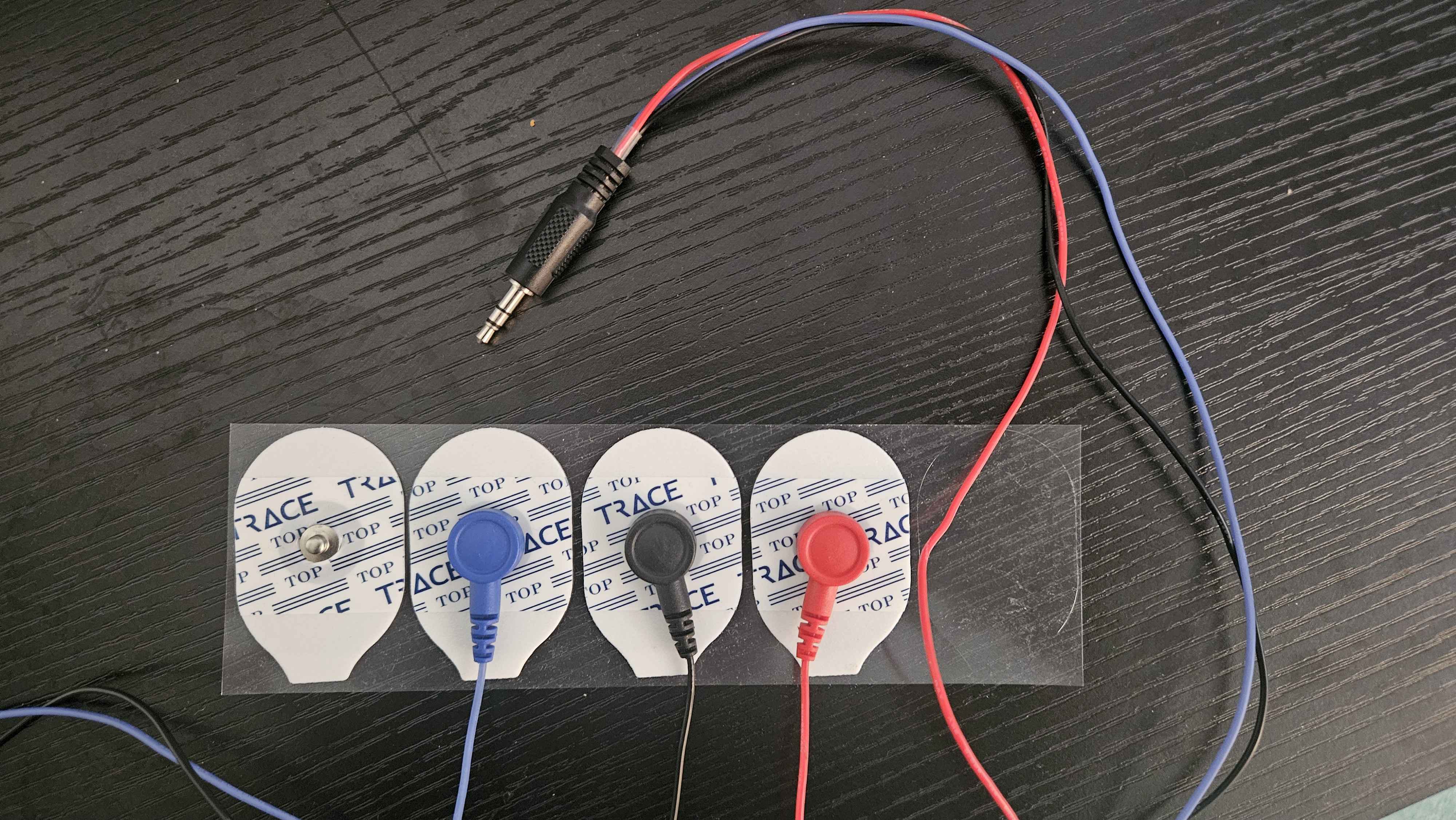 Snap ECG electrode pads laid out on a table with colour-coded leads